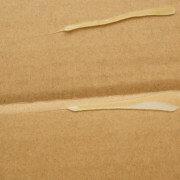 two stripes of low temperature hot melt adhesive on cardboard
